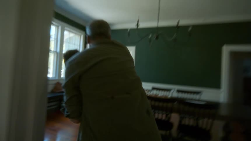 A drunk and abusive father yells and attacks his teenage son, dragging him through the house as the terrified mother flees the scene