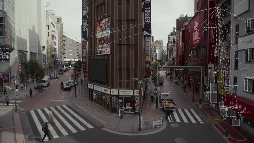 AI-powered surveillance system uses facial recognition and object tracking on pedestrians and vehicles at a busy city intersection