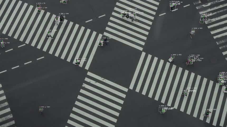 High-angle view of artificial intelligence software identifying and tracking pedestrians as they navigate a busy city crosswalk