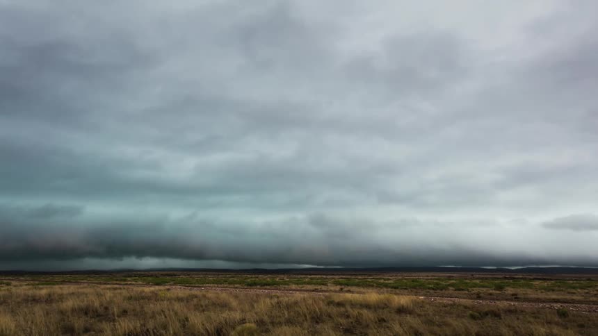 The heavy clouds move fast over the field