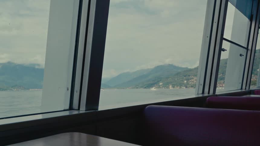 Scenic view of a tranquil mountain lake from the window of a passenger ferry
