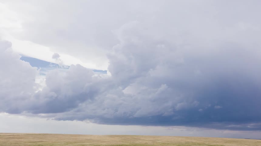 Clouds move around in the blue sky