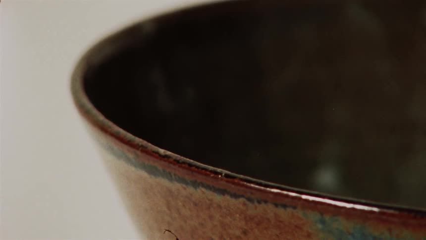 An extreme close-up view of the detailed glaze on a handmade pottery bowl