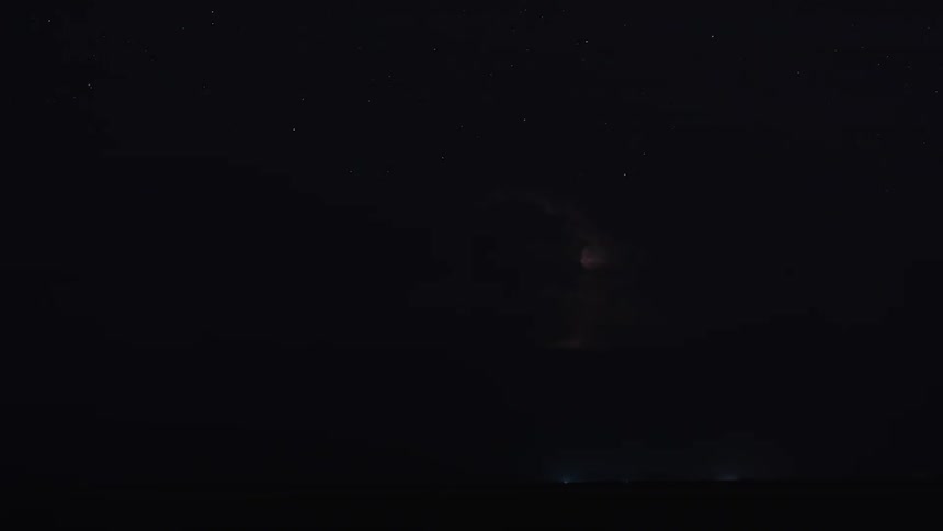Lightning storm flashes over plains at night