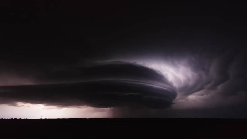 Time lapse of a lightning storm flashing over plains at night