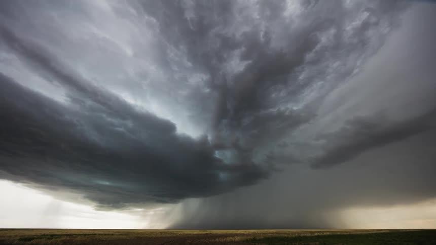 Time lapse of clouds rolling over plains in the evening