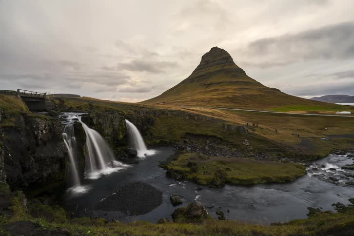 Watch the people cross the plains over a waterfall