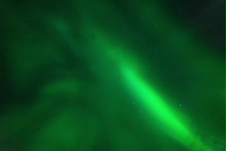 The sky is flaring with green light
