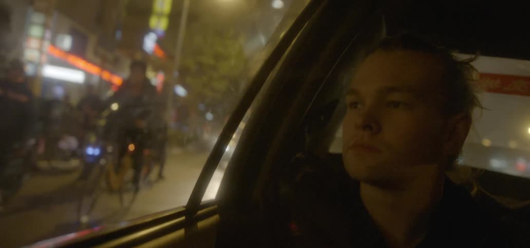 Man sitting in a car dejectedly looking out the window