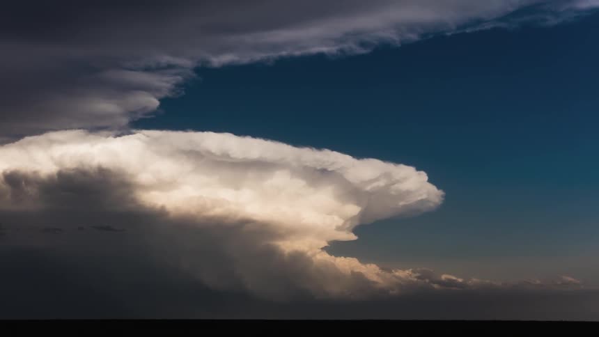 White fluffy clouds roll over plains