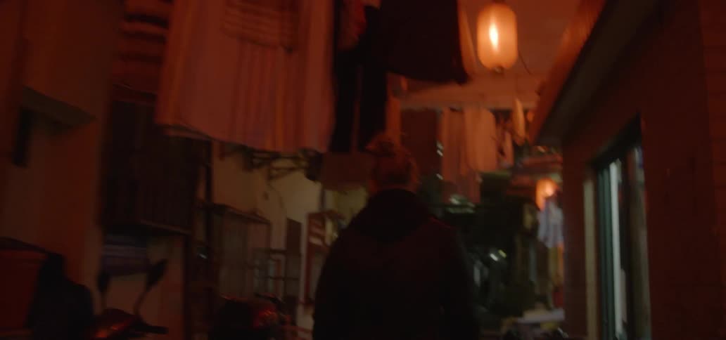 A man walks in a city at night