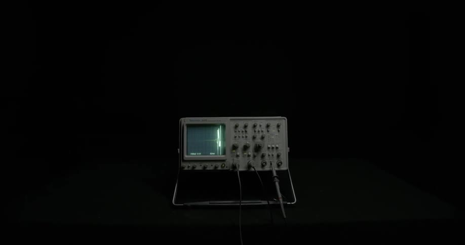 A medical monitor is flashing in a dark room