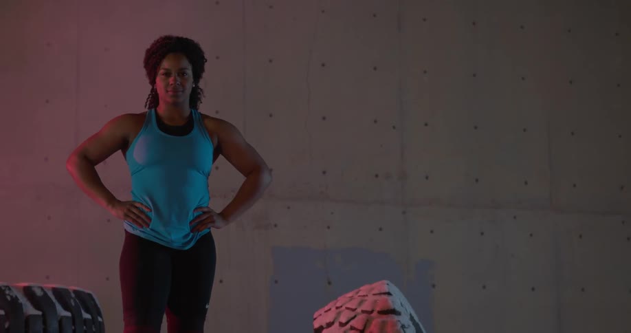 A woman poses in front of a wall