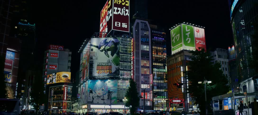 A slow crane-down shot of vibrant neon signs and anime billboards illuminating a bustling street corner in Shinjuku, Tokyo at night