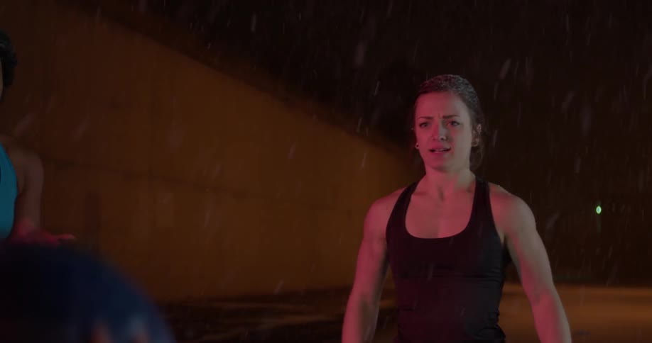 People are throwing a heavy ball back and forth at night