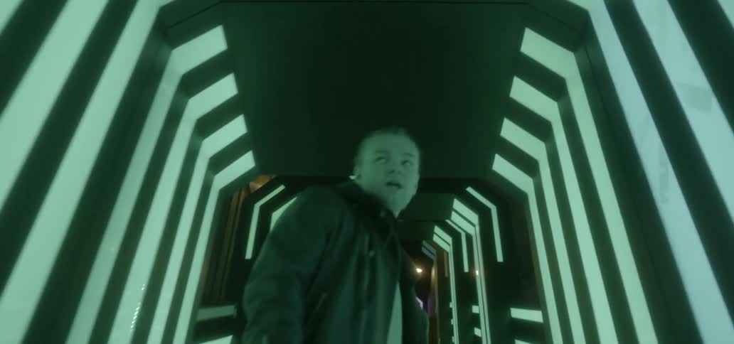 A man walks through a flashing tunnel