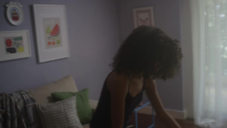 A woman is teaching a child how to dance