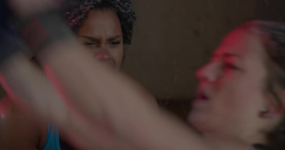 A woman is cheering on another woman working out