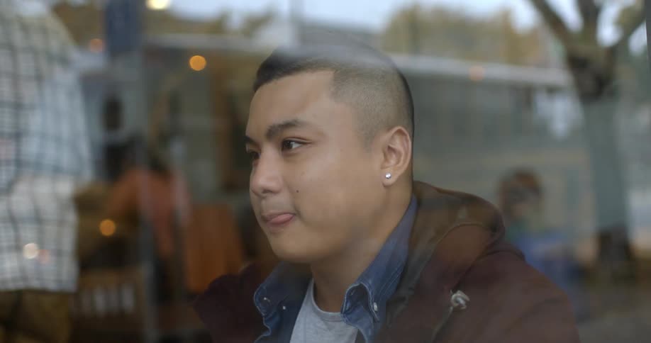 A man talks behind a window