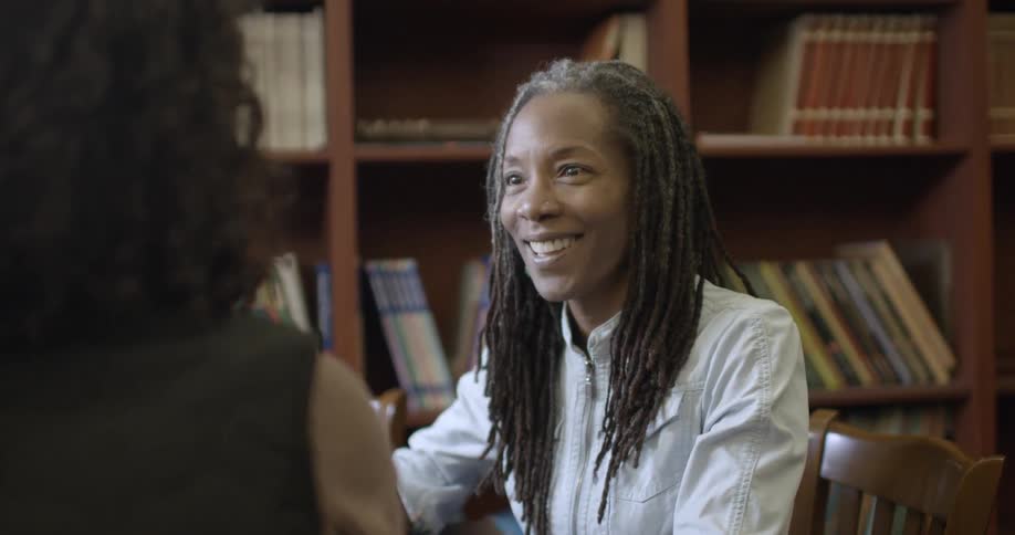 An older black woman is having a discussion with another woman