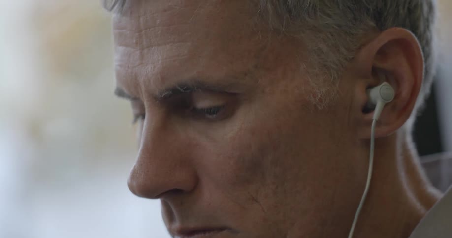 Close up of an elderly man wearing ear phones