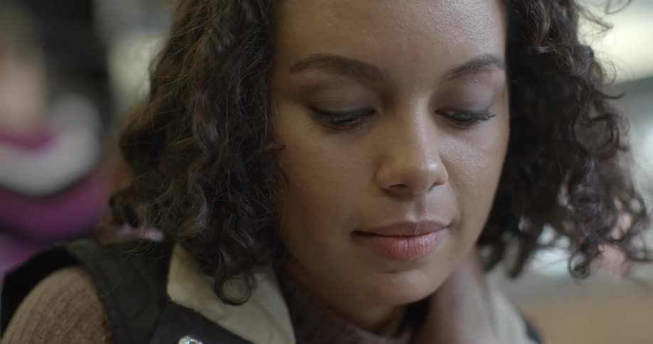 A woman smiles looking down