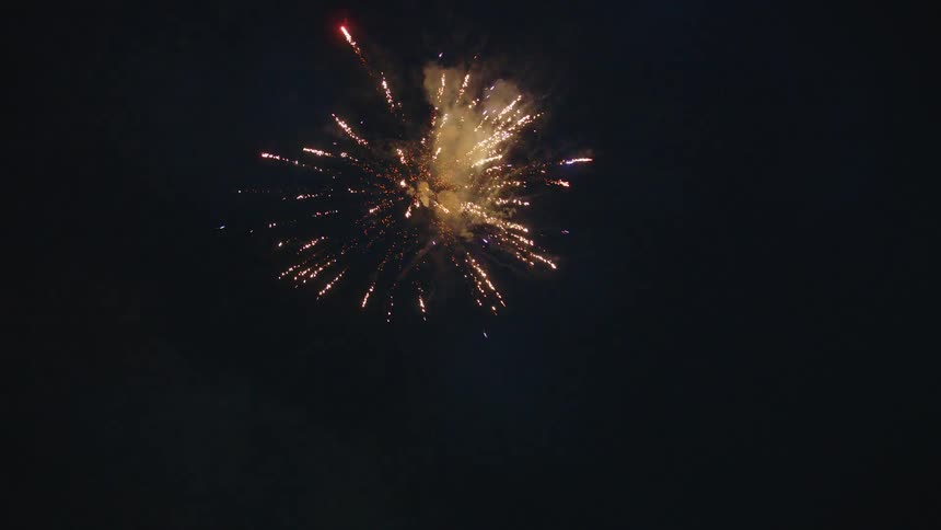 Colorful fireworks explode in a continuous display against the dark night sky