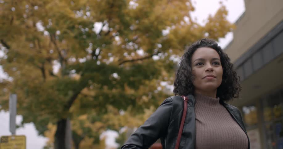 Woman standing on a city street on a fall day