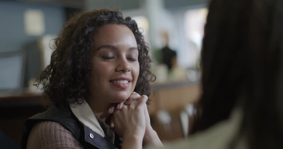 A woman talks and listens in a cafe