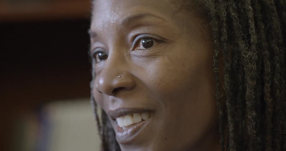 An older black woman is having a discussion and nodding her head