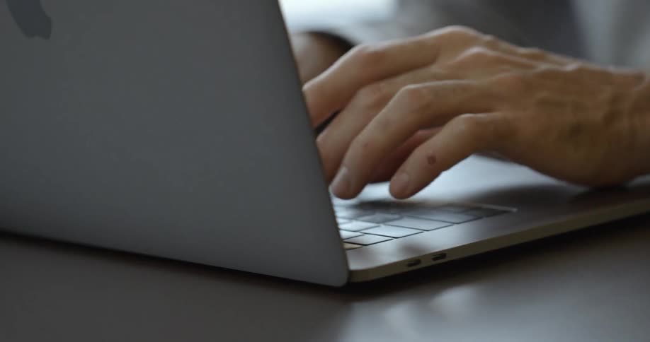 A person is typing on a laptop