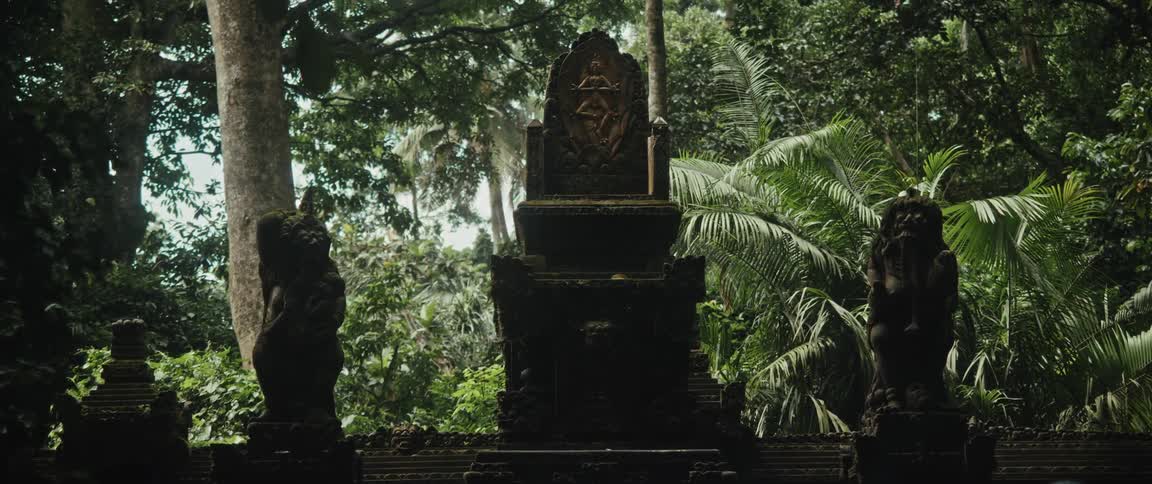An ancient, moss-covered stone throne sits guarded by statues deep within a lush, mystical jungle