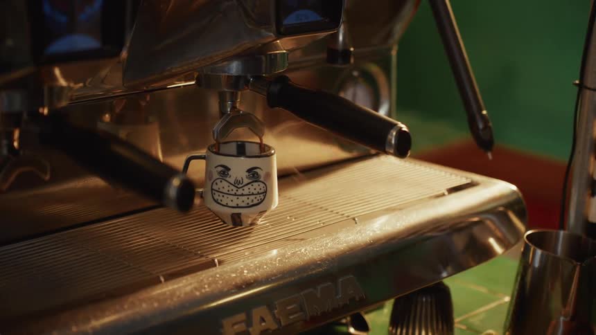 A steaming shot of espresso pours from a professional coffee machine into a whimsical mug with a smiling face