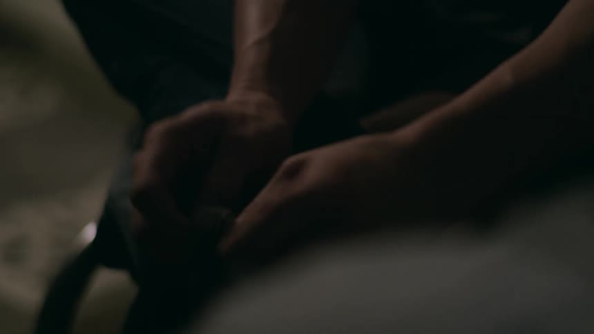 A person putting on their socks inside