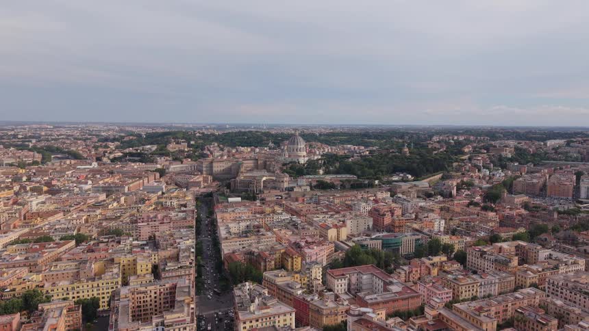 Static aerial shot captures the sprawling cityscape of Rome, Italy, with the dome of St. Peter's Basilica visible in the distance