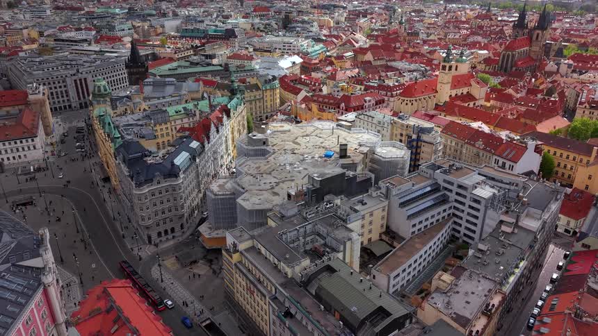 Slow zoom-out timelapse from a high angle reveals the sprawling cityscape of Prague with its historic red roofs and modern buildings