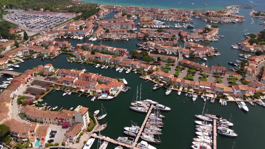 Static aerial drone view of the picturesque seaside town of Port Grimaud in the French Riviera, with its colorful houses and numerous yachts moored in the canals