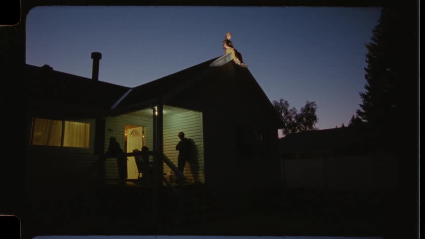 Nostalgic time-lapse footage shows young people hanging out at home as the sun sets, with one perched on the roof