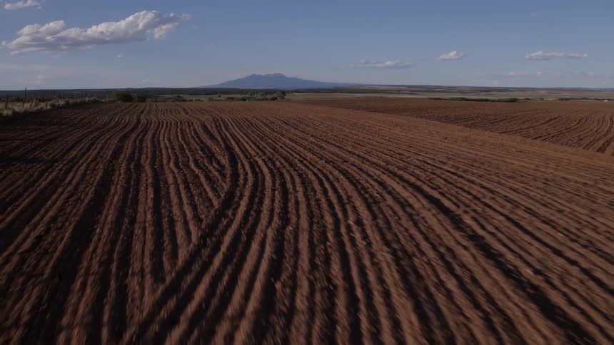 Plow tracks stretch out over newly plowed fields