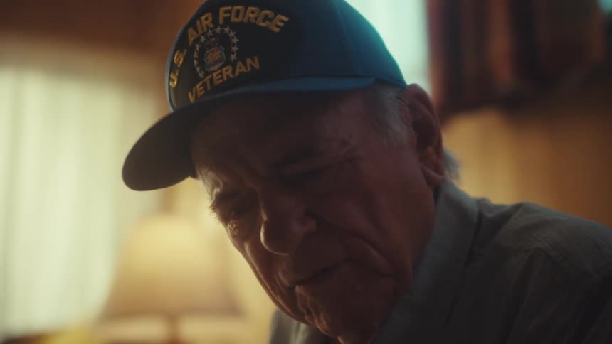A poignant close-up shows an elderly U.S. Air Force veteran lost in thought and memory