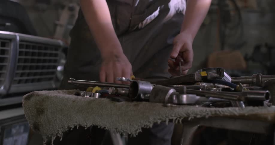 Person taking a tool to work on a truck