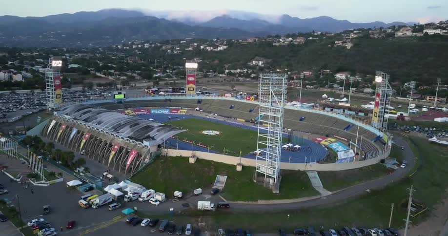 The stadium is empty and surrounded by cars outside
