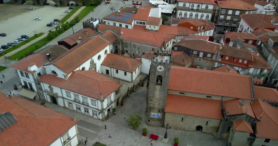 The city below has a row of buildings with one clock tower