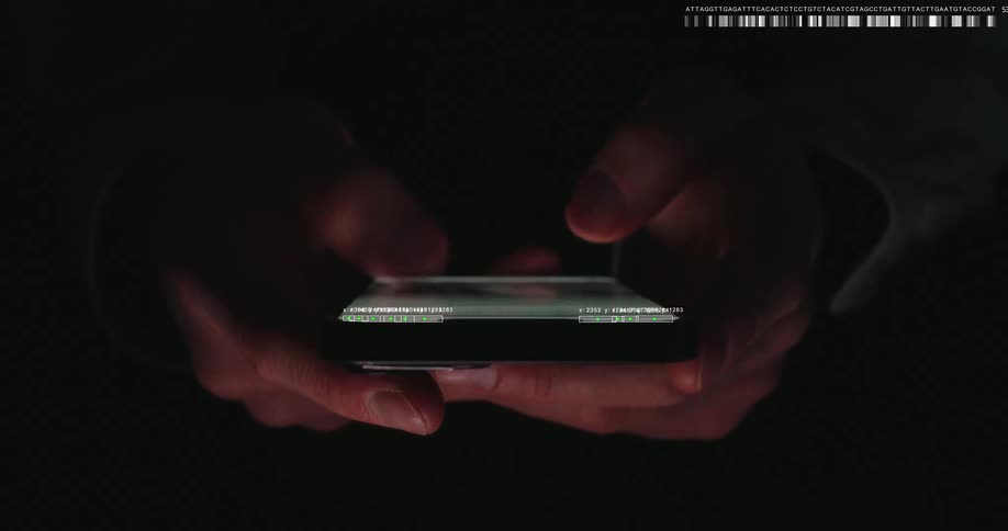 Close-up shot of hands scrolling through advanced data analysis and code on a smartphone in the dark