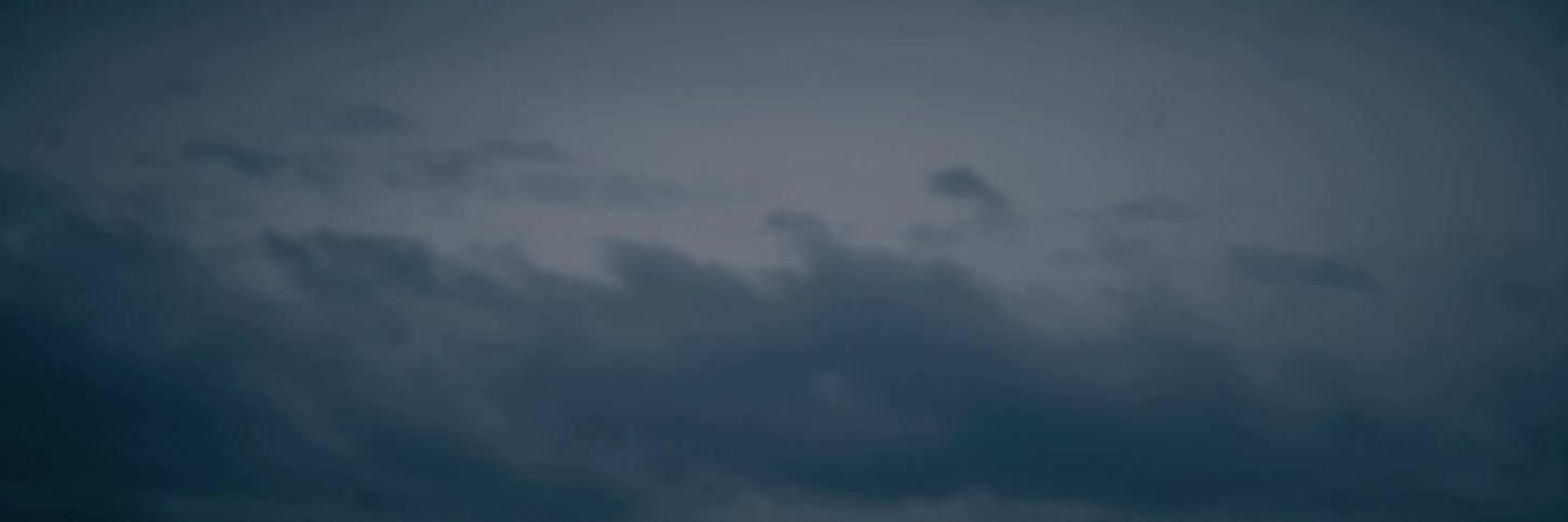 A soft focus abstract shot of a dark and gloomy sky at dusk