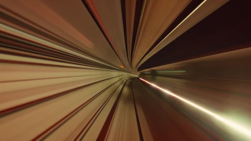 A mesmerizing point-of-view time-lapse shows a high-speed journey through a futuristic tunnel, creating abstract and colorful light trails
