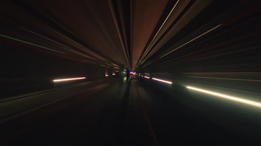 A fast-paced, psychedelic journey through a neon-lit subway tunnel with abstract, streaking light effects