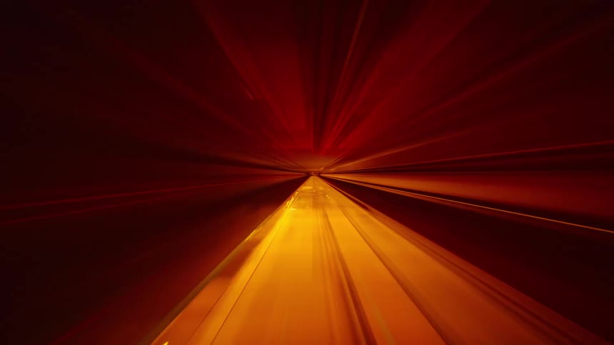 Abstract time-lapse of a high-speed journey through a futuristic red and orange glowing tunnel