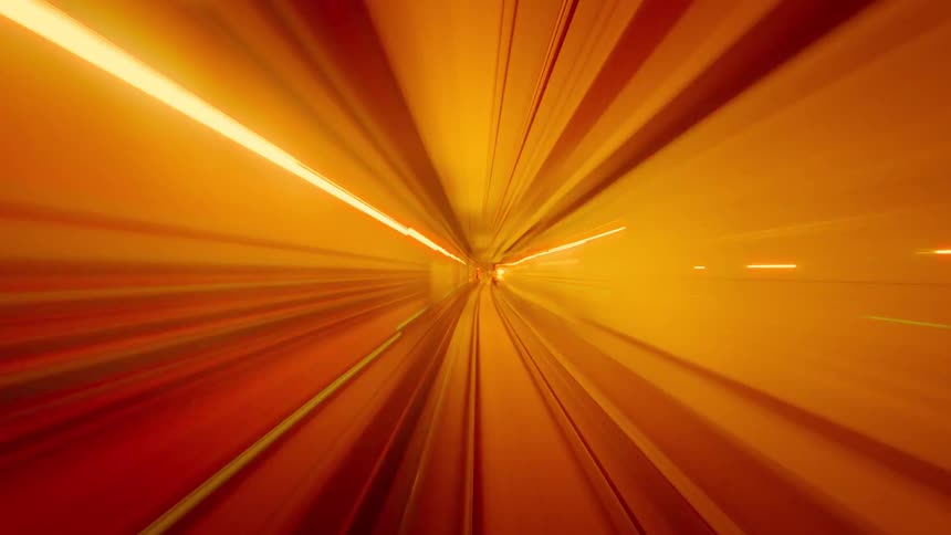 Abstract point-of-view time-lapse of a high-speed journey through a futuristic tunnel with red and orange light trails