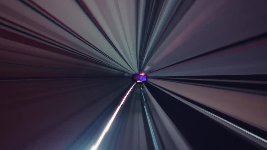 A futuristic point-of-view journey speeds through a subway tunnel creating abstract, colorful light trails